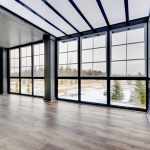 Large empty room with floor to ceiling windows