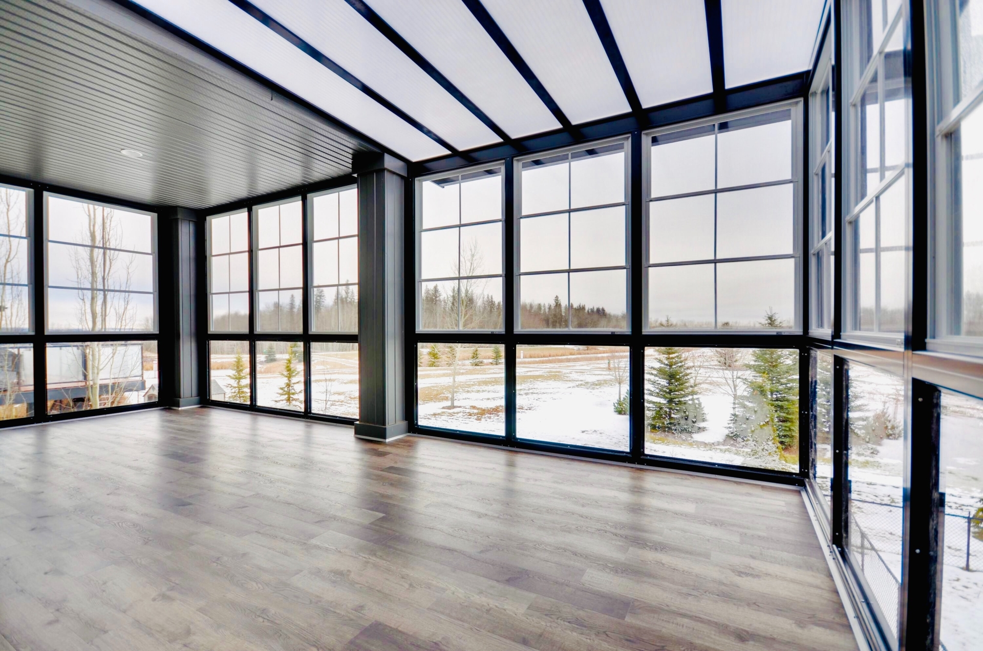 Large empty room with floor to ceiling windows