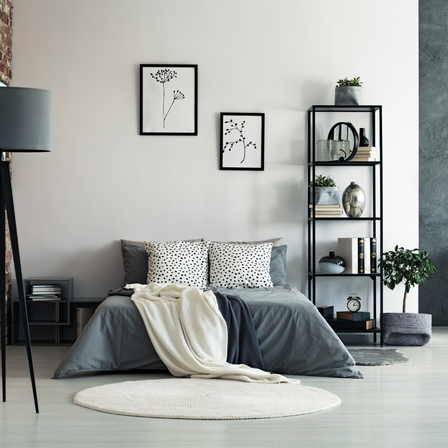 Loft style room with bed and couch in grey and neutral colors