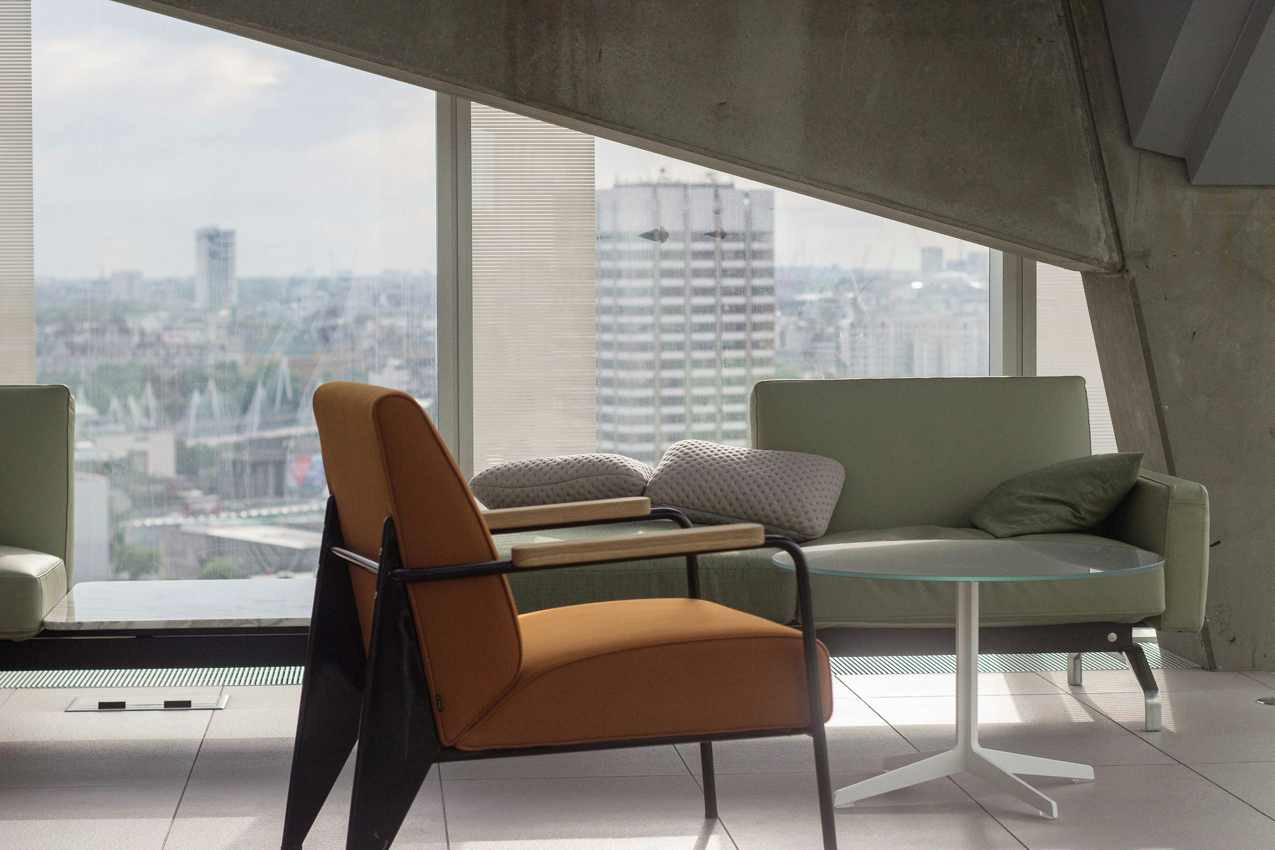 Modern sofa and chair infront of a window looking over a city